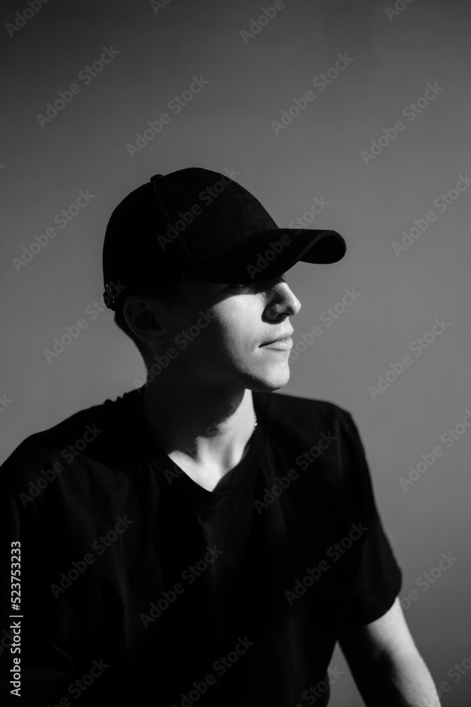 Portrait of stylish handsome caucasian man fashion model in t shirt and cap, studio shot. Portrait of stylish handsome caucasian man fashion model in t shirt and cap, studio shot.