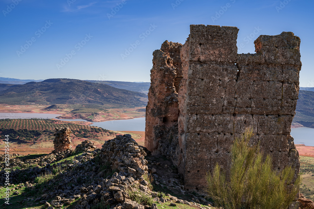 Ruins of the Giribaile castle on top of a hill overlooking the reservoir, second photo. Photography made in Jaen, Andalusia, Spain.