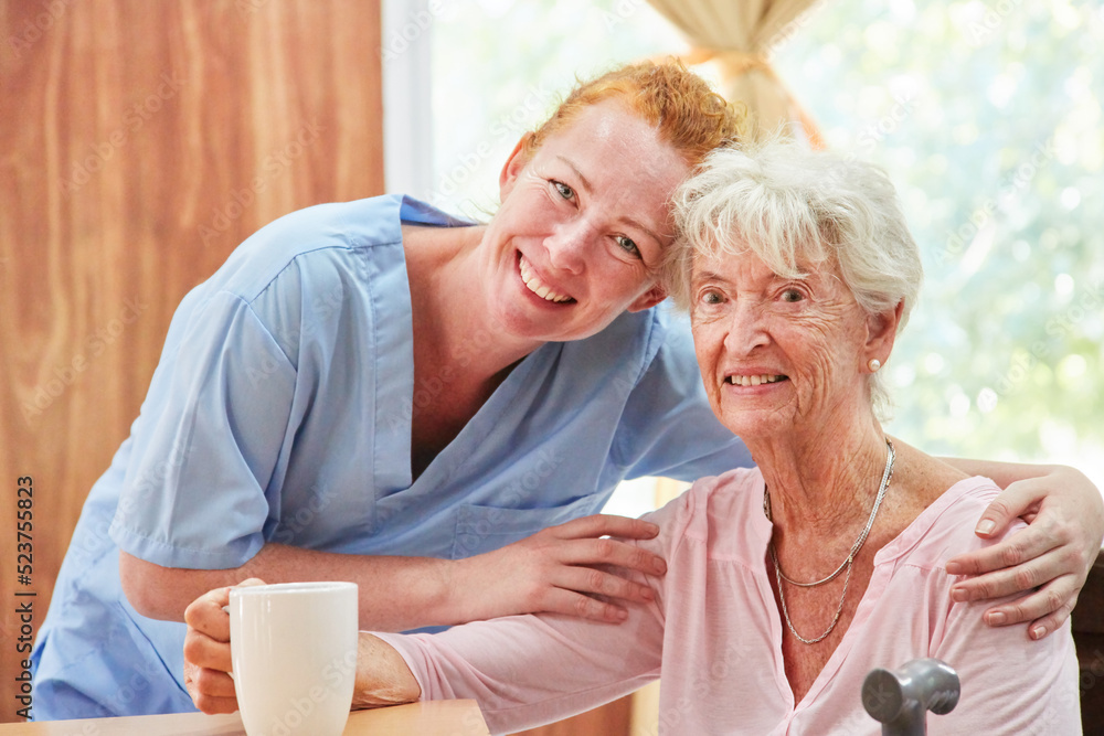 Smiling and caring caregiver and old woman Smiling and caring caregiver and old woman