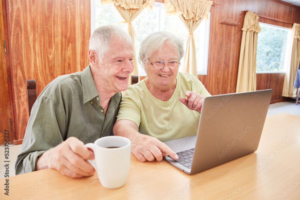 Senior couple having fun video chatting on laptop Senior couple having fun video chatting on laptop