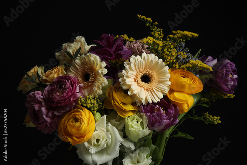 Beautiful fresh flowers on dark background, closeup photo