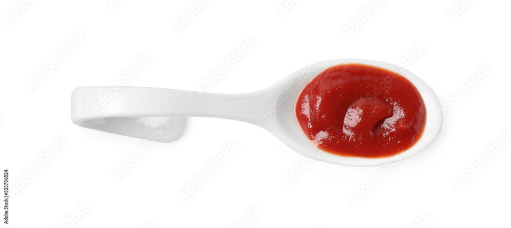 Ketchup in ceramic serving spoon isolated on white, top view Ketchup in ceramic serving spoon isolated on white, top view