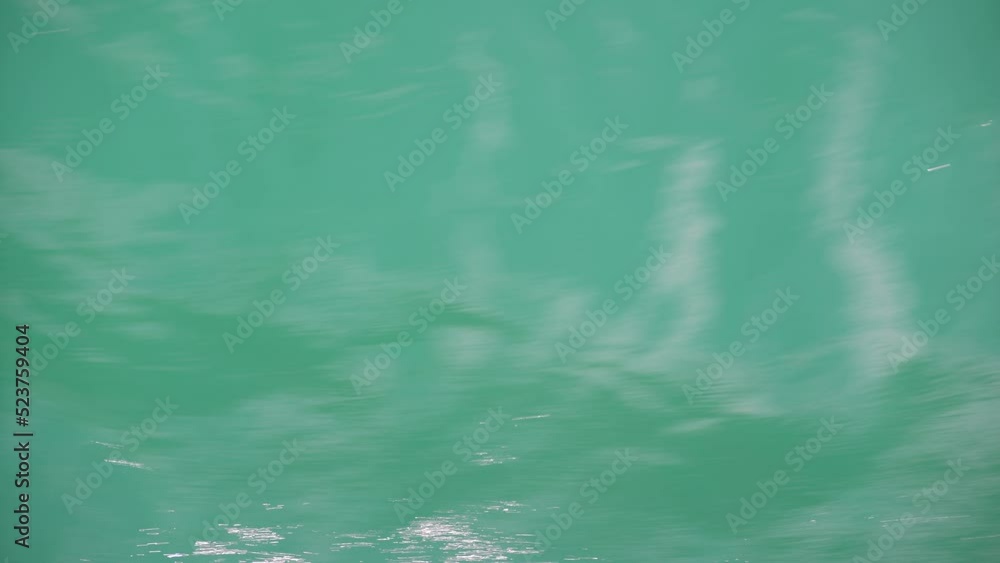 Reflection in water and ripples in a lake. Water wave background Reflection in water and ripples in a lake. Water wave background