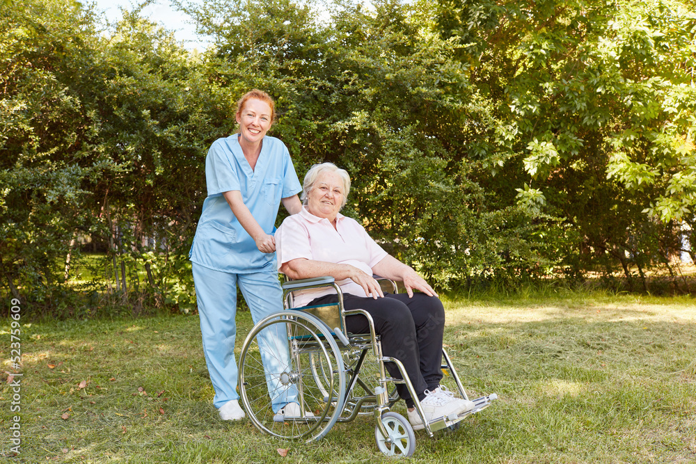 Geriatric nurse and old woman in a wheelchair in the park Geriatric nurse and old woman in a wheelchair in the park
