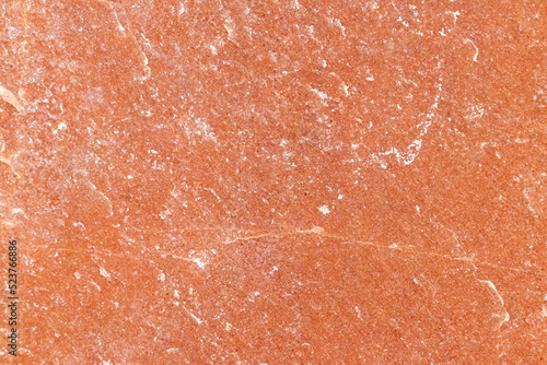 Texture of a stone wall with cracks and scratches which can be used as a backgr. Texture of red stone.