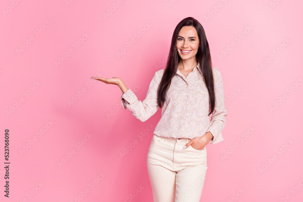 Photo of young attractive woman professional experience smiling recommend hold hand new product high quality isolated on pink color background Photo of young attractive woman professional experience smiling recommend hold hand new product high quality isolated on pink color background