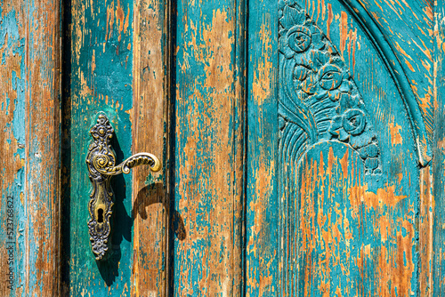 Old wooden weathered and shabby door with knob