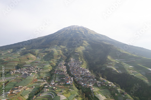 Nepal Van java, A small village known for its colorful houses on a slope set against a dramatic mountain view.