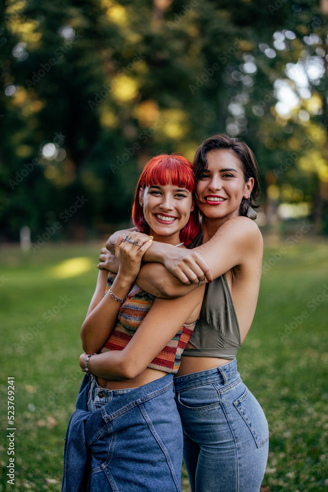 Portrait of two lesbian girl, hugging from behind, posing for the camera. Portrait of two lesbian girl, hugging from behind, posing for the camera.