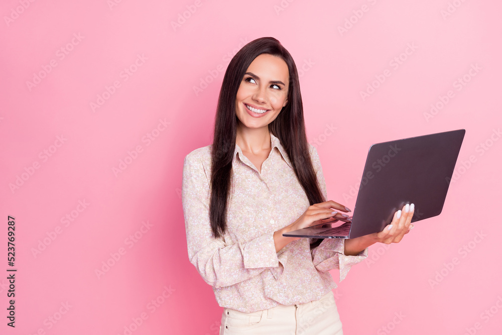 Portrait photo of young cute lady hold computer laptop touchpad user got idea look empty space isolated on pink color background Portrait photo of young cute lady hold computer laptop touchpad user got idea look empty space isolated on pink color background