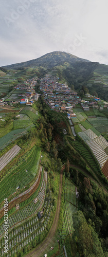 Nepal Van java, A small village known for its colorful houses on a slope set against a dramatic mountain view.
