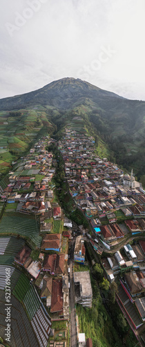 Nepal Van java, A small village known for its colorful houses on a slope set against a dramatic mountain view.