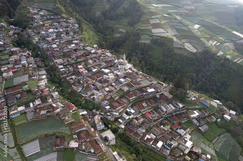 Nepal Van java, A small village known for its colorful houses on a slope set against a dramatic mountain view.