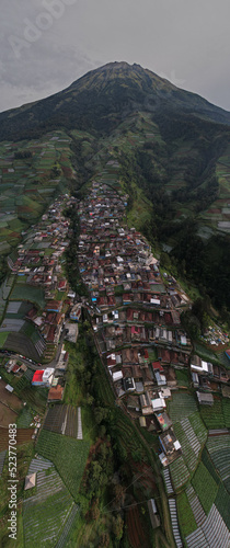 Nepal Van java, A small village known for its colorful houses on a slope set against a dramatic mountain view.
