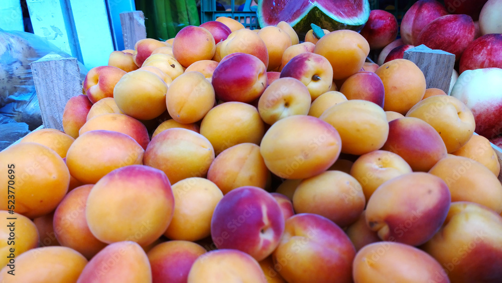 Fresh fruits. Yellow orange peaches nectarines on supermarket shelves. Retail industry. Local Farmers market. Discount. Rising food price. Rich harvest. Grocery store. Shopping sale. Selective focus. Fresh fruits. Yellow orange peaches nectarines on supermarket shelves. Retail industry. Local Farmers market. Discount. Rising food price. Rich harvest. Grocery store. Shopping sale. Selective focus.