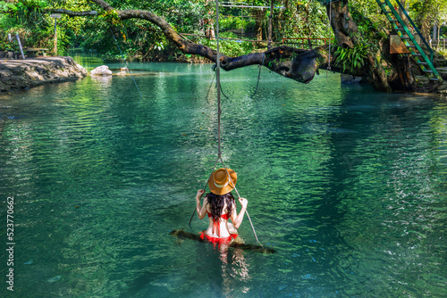 Young Asian tourists enjoying the Blue Lagoon in Vang Vieng, Laos.