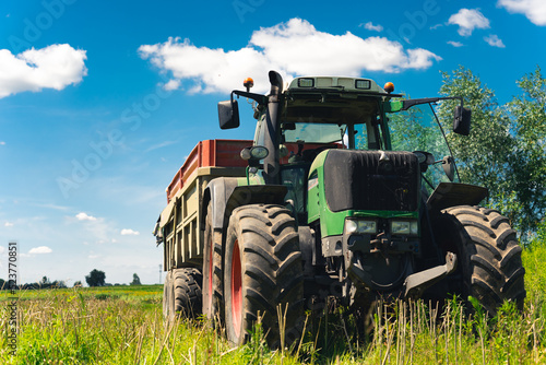 a tractor taking away the crop from the field. High quality photo