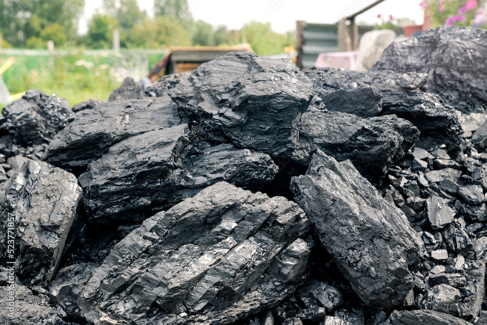 Mountain of coarse coal for housing heating. Energy and fuel industry. Volcanic rock.