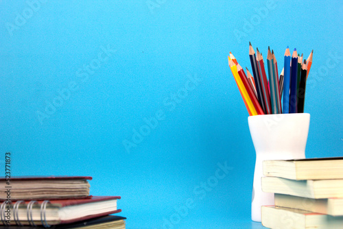 Education elements books, pens, pencils isolated on light blue background. used in Back to school poster, brochure templated design