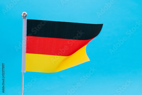 German flag waving on blue background