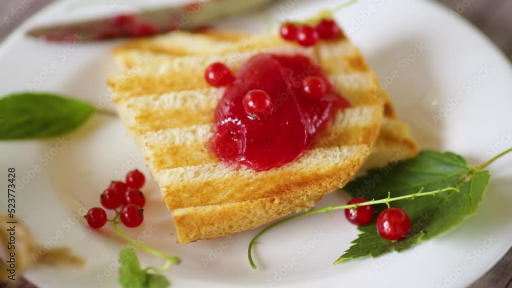 fried bread croutons for breakfast with redcurrant jam in a plate with berries fried bread croutons for breakfast with redcurrant jam in a plate with berries