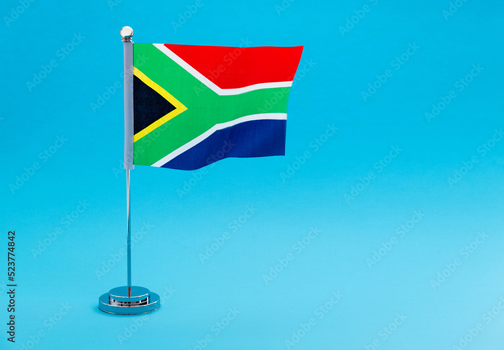 Naklejka premium South Africa table flag waving on blue background