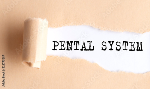 The text PENTAL SYSTEM appears on torn paper on white background. photo