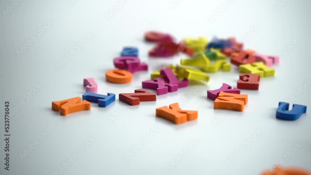 Spinning colored letters on a white table. Close-up conceptual shot of alphabet letters falling on a white background. Representing memory loss, brainstorming, writing, amnesia. 4k video Spinning colored letters on a white table. Close-up conceptual shot of alphabet letters falling on a white background. Representing memory loss, brainstorming, writing, amnesia. 4k video
