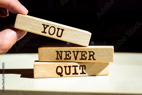 Wooden blocks with words 'You Never Quit'.