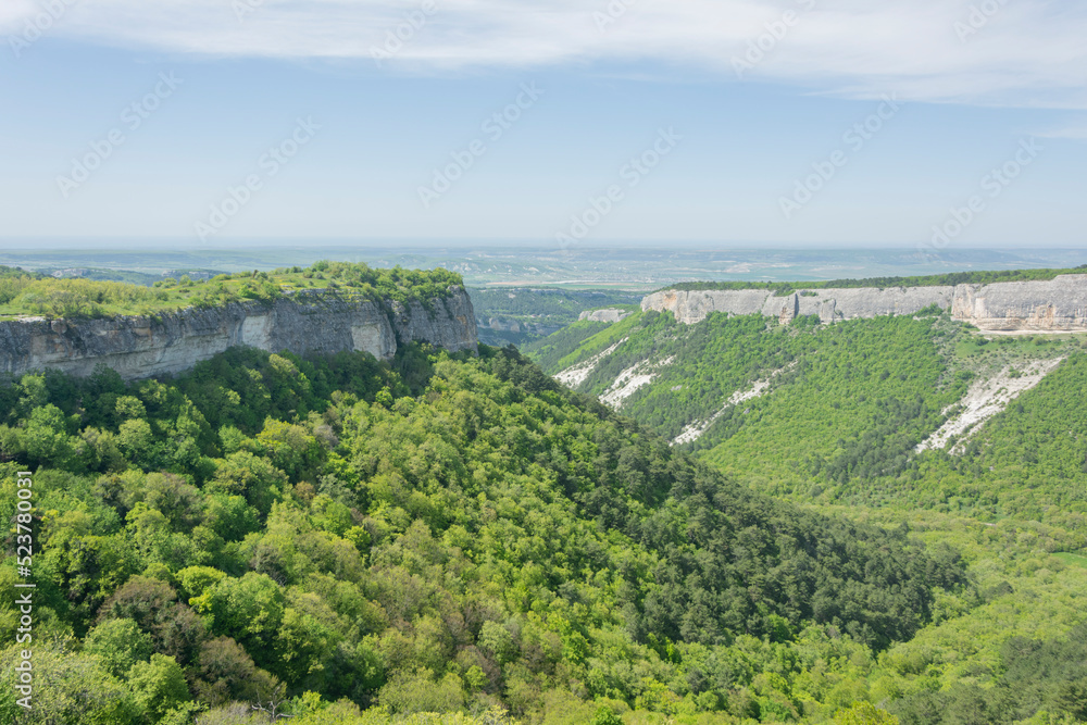View from the plain to the mountain peaks. Nature background mountain clouds. View from the top to the plain View from the plain to the mountain peaks. Nature background mountain clouds. View from the top to the plain