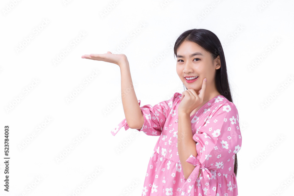Asian beautiful woman with black long hair in pink shirt shows present something on white background. Asian beautiful woman with black long hair in pink shirt shows present something on white background.
