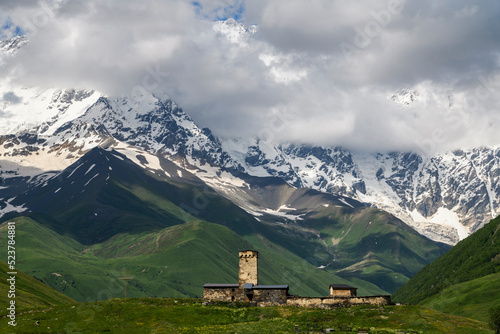 Old tower and Shkhara mountains, the highest point in the nation of Georgia It is located near the Russian-Georgian border, in Russia's Kabardino-Balkaria region. 