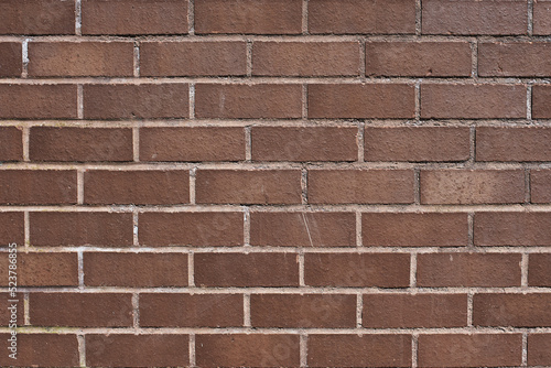 The texture of a neat brown stone. Smooth brickwork with brown smooth stone. The texture of the wall of the English house.