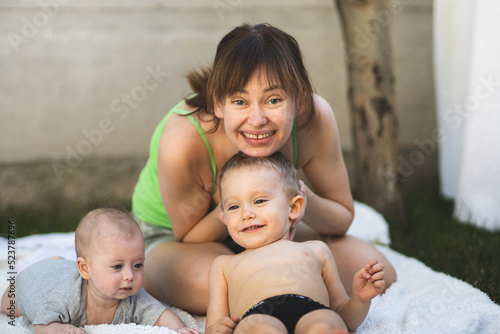 The mother of two children plays with them and enjoys life. A mother and her two children. Mother of two. Happy motherhood.