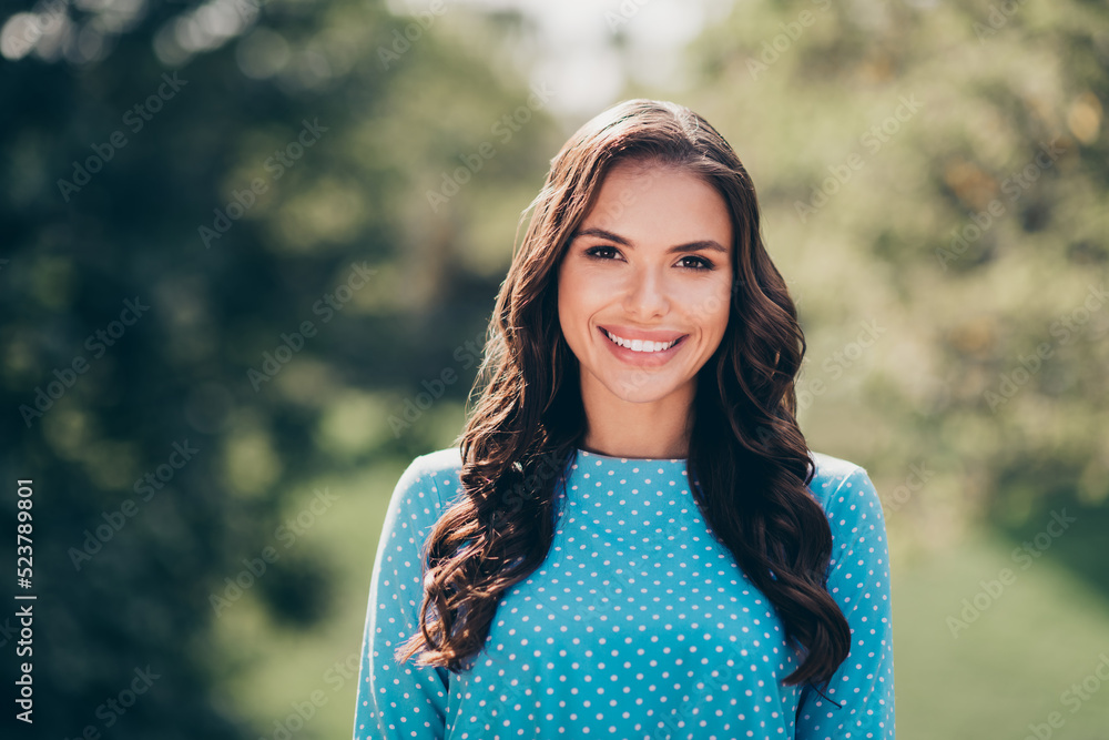 Photo of young attractive pretty cheerful girl wear blue dress photo session look toothy smiling in forest park Photo of young attractive pretty cheerful girl wear blue dress photo session look toothy smiling in forest park