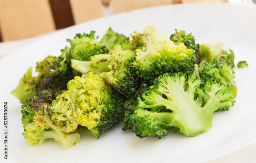 fried inflorescences of broccoli with provencal herbs on white plate fried inflorescences of broccoli with provencal herbs on white plate