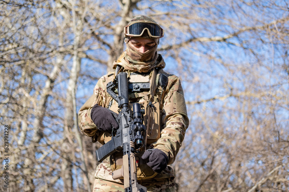 Male modern soldier in the autumn forest 