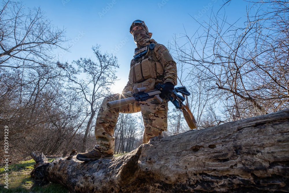 Male modern soldier in the autumn forest Male modern soldier in the autumn forest