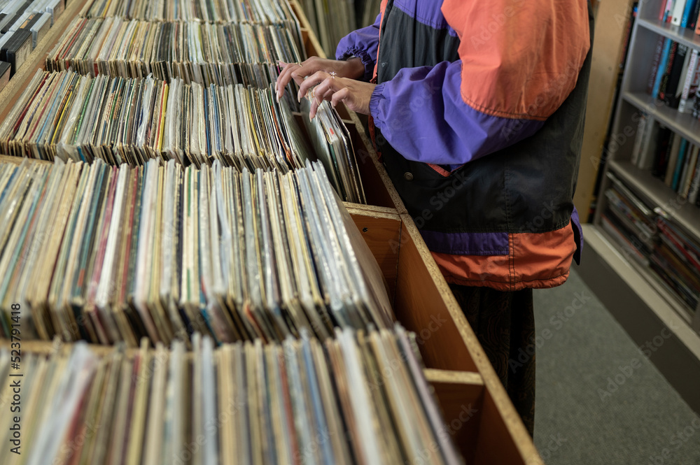 Woman seen searching through vinyl records