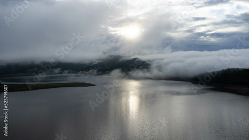 Aerial view from drone  beautiful view of morning mist covering forests and mountains with calm rivers.  Lam Taphen Reservoir   Kanchanaburi Province  Thailand