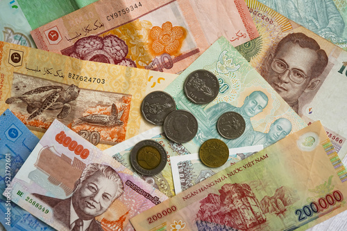 Asian banknotes and coins from different countries - thai baht, vietnamese dong, malaysian ringgit, lao kip