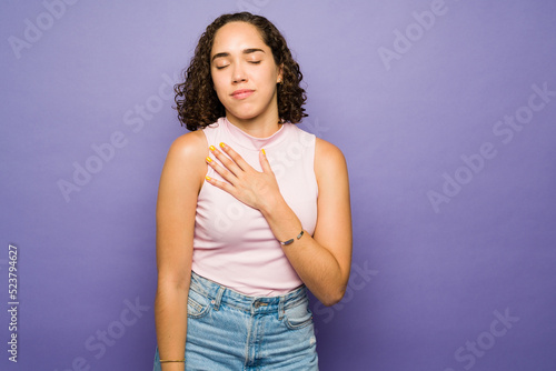 Thankful woman in her 20s feeling grateful and loved