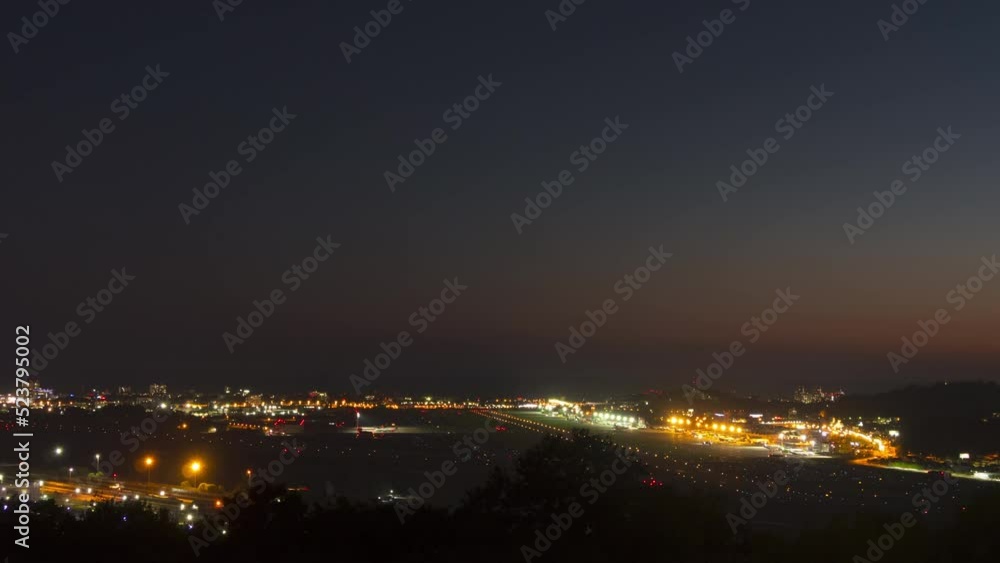 Generic international airport airfield night timelapse with moving lights from commercial jet airliners. Tourism and travel concept Generic international airport airfield night timelapse with moving lights from commercial jet airliners. Tourism and travel concept
