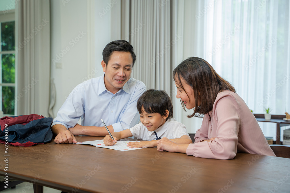 Parents helping little son with school homework,Homeschooling concept. Parents helping little son with school homework,Homeschooling concept.