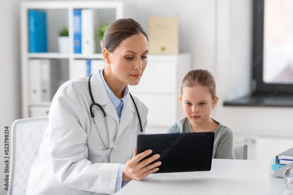 medicine, healthcare and pediatry concept - female doctor or pediatrician showing tablet computer to little girl patient at clinic medicine, healthcare and pediatry concept - female doctor or pediatrician showing tablet computer to little girl patient at clinic