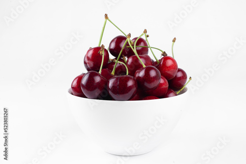 Sweet cherry. Cherries in a bowl. On a white background.