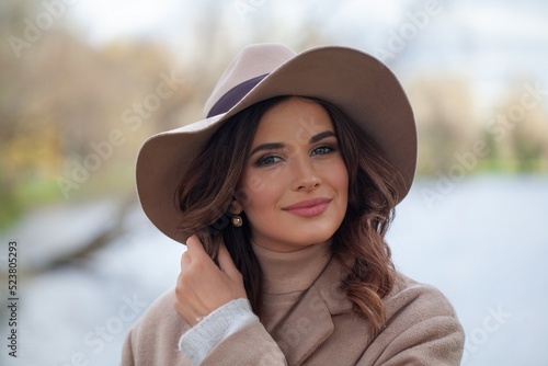 Stylish woman smiling, outdoors portrait © millaf