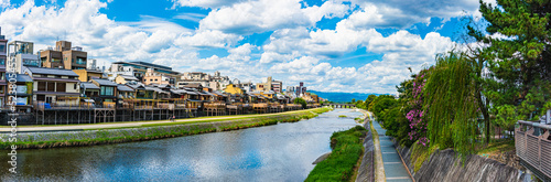 Panoramic view of Kyoto Kamo river -Kamogawa- river side view under dynamic blue sky in Kyoto, Japan. © DRN Studio