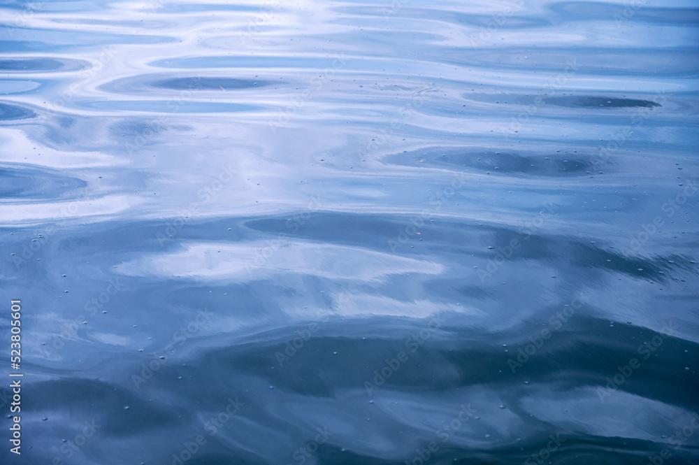 Sea surface. Blue water texture. Close up blue water surface at deep ocean Sea surface. Blue water texture. Close up blue water surface at deep ocean