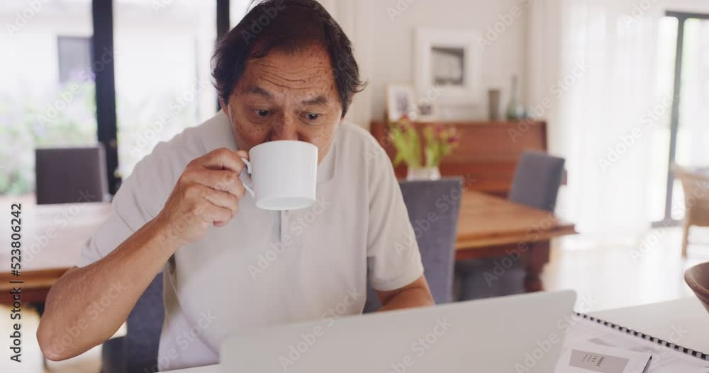 Household budget, finance planning and online banking with a senior asian man working on a laptop and drinking coffee. Mature male checking his investment and savings while banking in the kitchen Household budget, finance planning and online banking with a senior asian man working on a laptop and drinking coffee. Mature male checking his investment and savings while banking in the kitchen